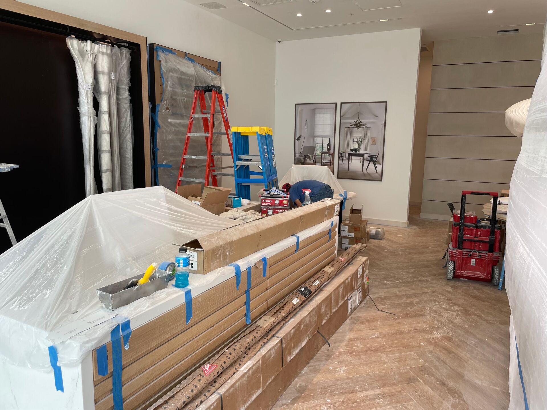 Retail fixture installation in progress, with fixtures protected during finish work